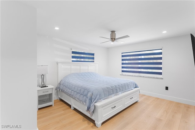 bedroom with ceiling fan and light hardwood / wood-style flooring