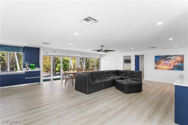 living room featuring ceiling fan and light hardwood / wood-style floors