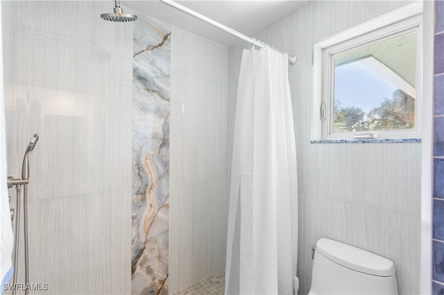 bathroom with a shower with shower curtain and toilet