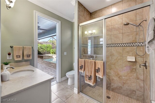 bathroom featuring toilet, tile patterned flooring, ornamental molding, vanity, and walk in shower