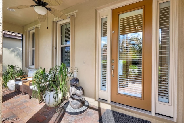 doorway to property featuring ceiling fan