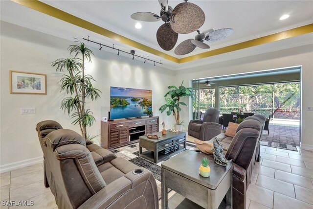 living room featuring ornamental molding, light tile patterned floors, and ceiling fan