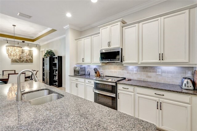 kitchen with white cabinetry, sink, appliances with stainless steel finishes, dark stone countertops, and crown molding