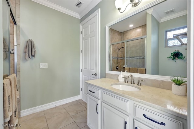 bathroom featuring vanity, tile patterned floors, a shower with door, and crown molding