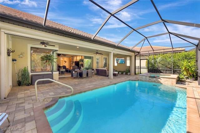 view of pool with an in ground hot tub, outdoor lounge area, a patio area, ceiling fan, and a lanai