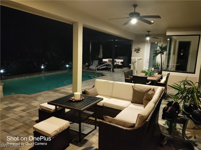 patio at twilight featuring ceiling fan and an outdoor hangout area