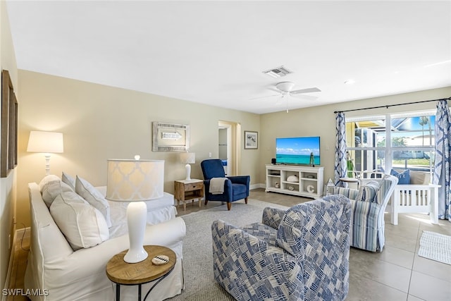 tiled living room with ceiling fan