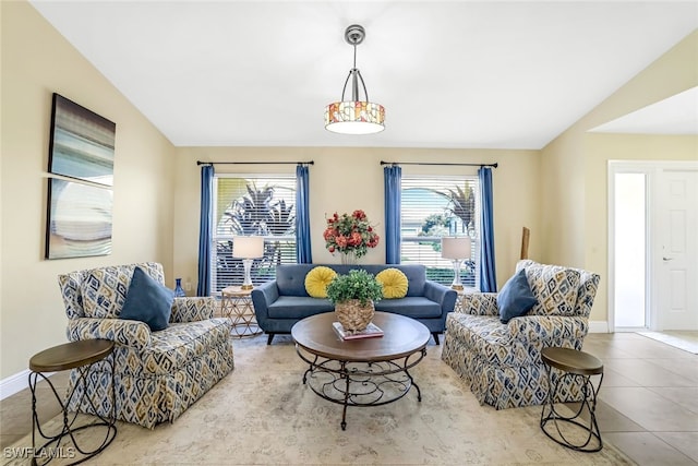 living room featuring lofted ceiling and light tile patterned floors