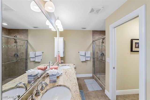 bathroom featuring walk in shower, vanity, and tile patterned floors