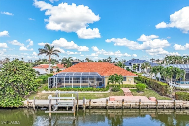 back of property featuring glass enclosure and a water view