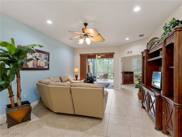 tiled living room featuring ceiling fan