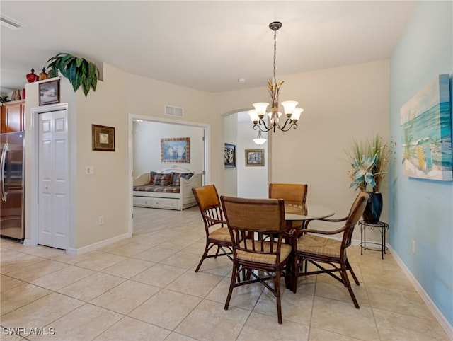 tiled dining area with a notable chandelier