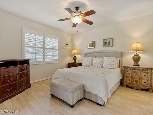 bedroom with light hardwood / wood-style flooring and ceiling fan