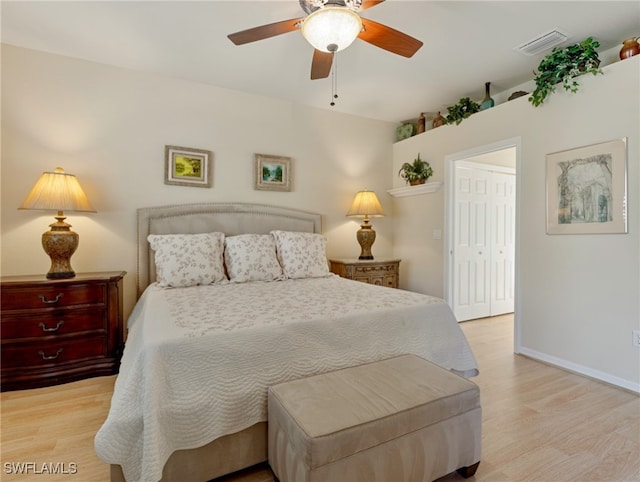 bedroom featuring a closet, light wood-type flooring, and ceiling fan