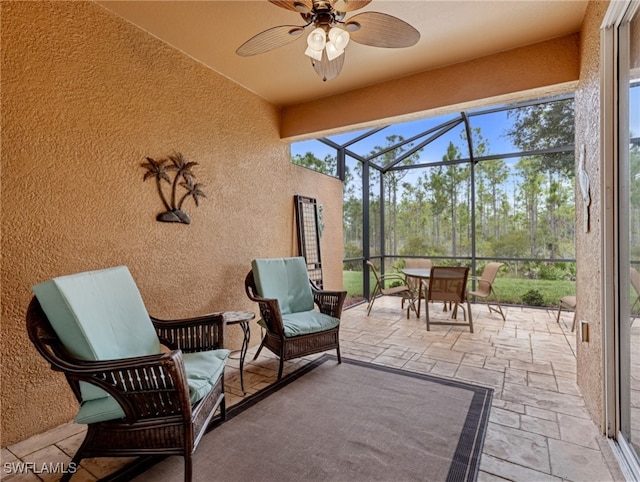 sunroom featuring ceiling fan