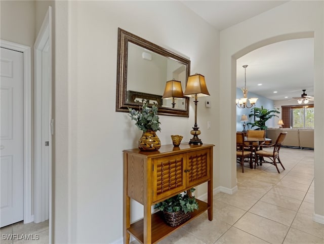 hall featuring an inviting chandelier and light tile patterned floors