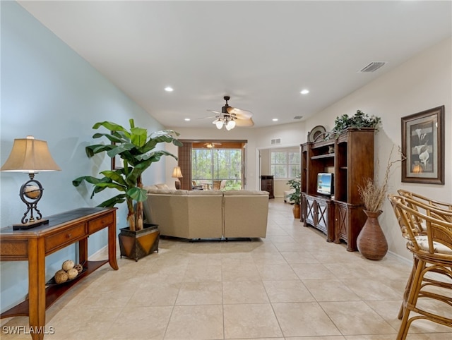 living room featuring light tile patterned flooring and ceiling fan