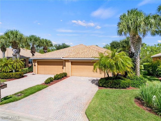 view of front of house with a front yard and a garage