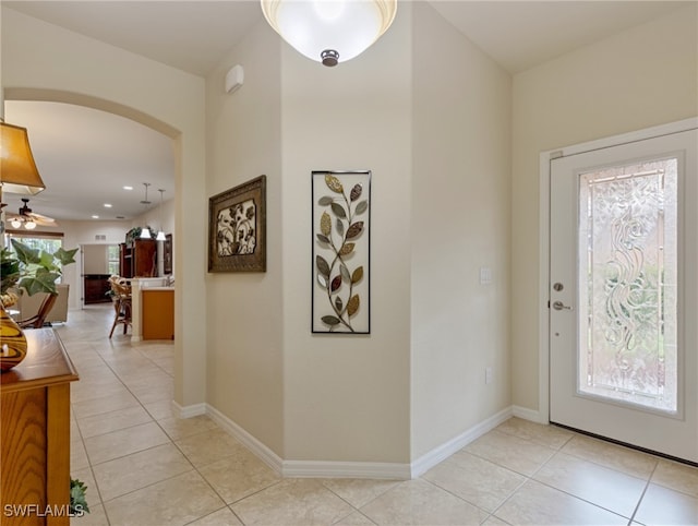 tiled entryway featuring ceiling fan