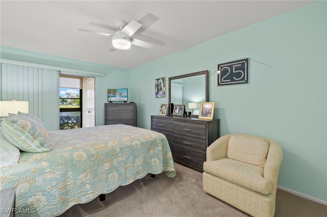 carpeted bedroom with ceiling fan, access to exterior, and a textured ceiling