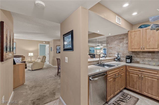 kitchen featuring dishwasher, sink, light carpet, kitchen peninsula, and decorative backsplash