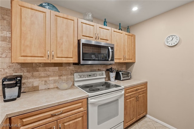 kitchen with backsplash, electric range, light brown cabinets, and light tile patterned floors