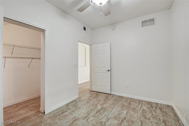 unfurnished bedroom with ceiling fan, a closet, and light hardwood / wood-style floors