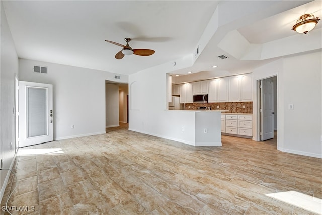 unfurnished living room featuring ceiling fan