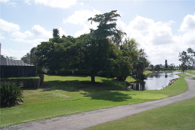 view of property's community featuring a water view and a lawn