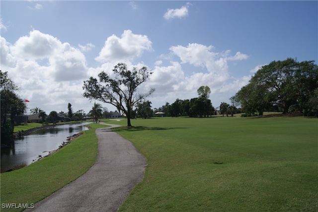 view of property's community featuring a yard and a water view