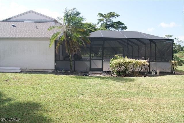 view of yard with glass enclosure