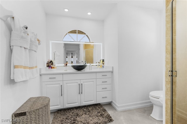 bathroom featuring vanity, toilet, and walk in shower