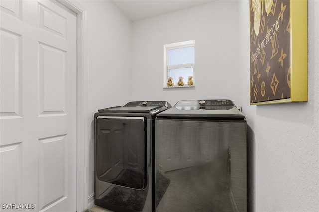 clothes washing area featuring washer and dryer