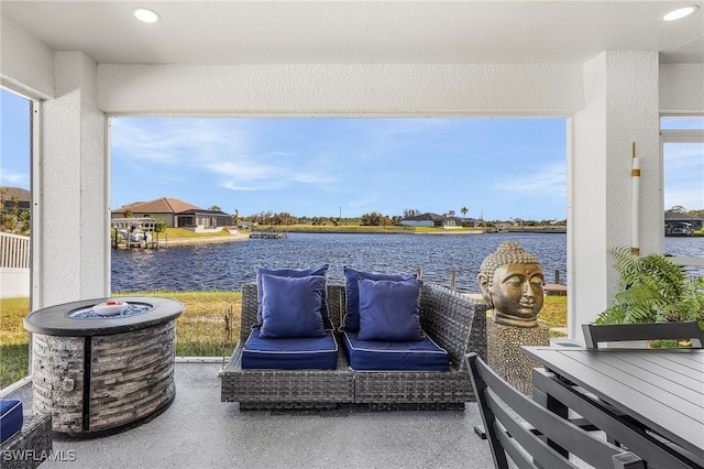 view of patio with a water view