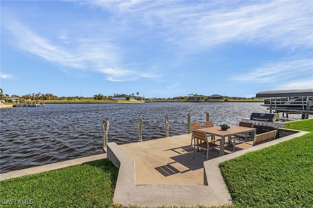 dock area featuring a lawn and a water view