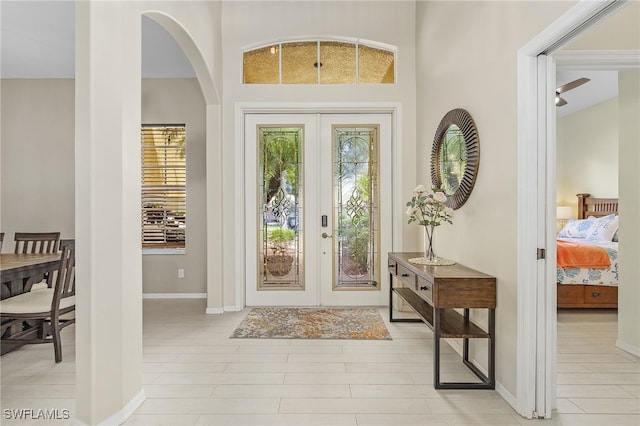 foyer entrance with french doors and light wood-type flooring