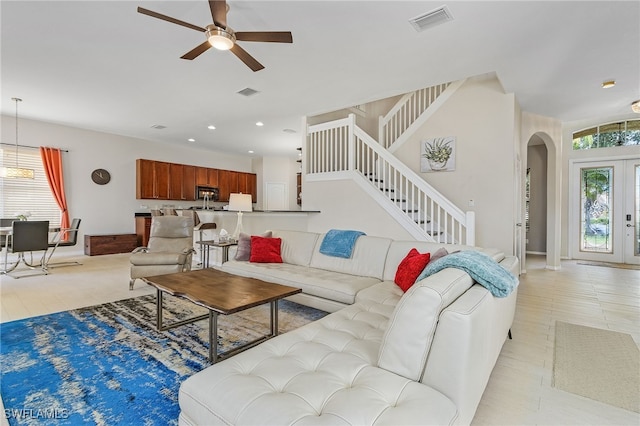 living room with french doors, light tile patterned floors, and ceiling fan