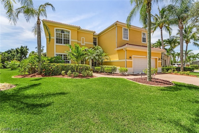 mediterranean / spanish-style home with a front yard and a garage