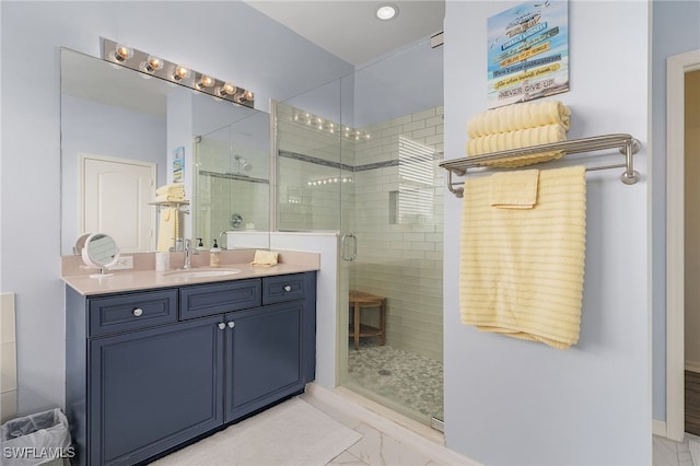 bathroom featuring vanity and a shower with door