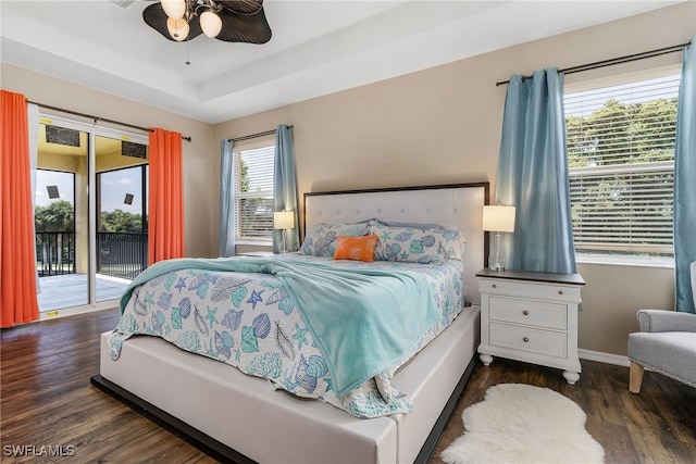 bedroom featuring access to exterior, ceiling fan, multiple windows, and dark hardwood / wood-style flooring