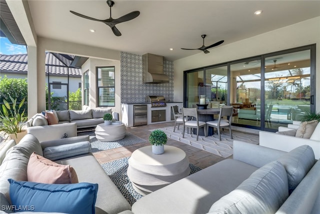 view of patio / terrace with outdoor lounge area, an outdoor kitchen, ceiling fan, and a grill