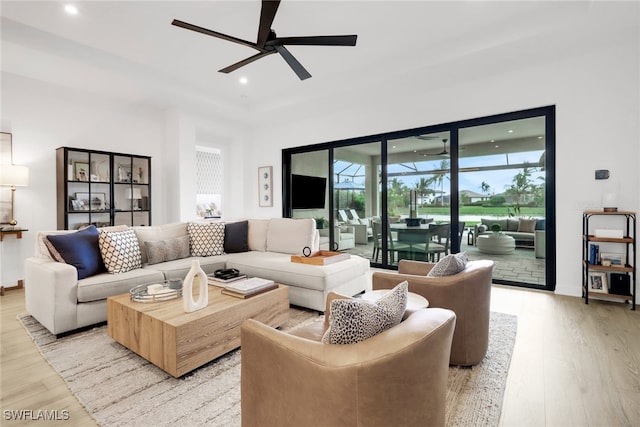 living room with ceiling fan and light wood-type flooring