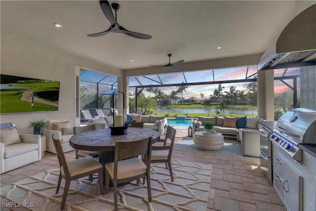 sunroom / solarium featuring a water view