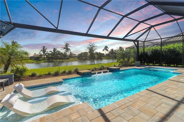 pool at dusk with glass enclosure, pool water feature, and a water view