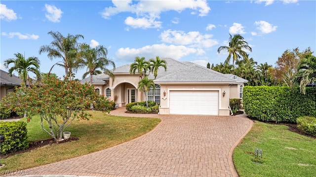 view of front of house with a garage and a front yard