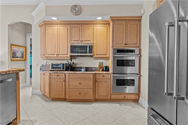 kitchen featuring appliances with stainless steel finishes, crown molding, and light tile patterned flooring