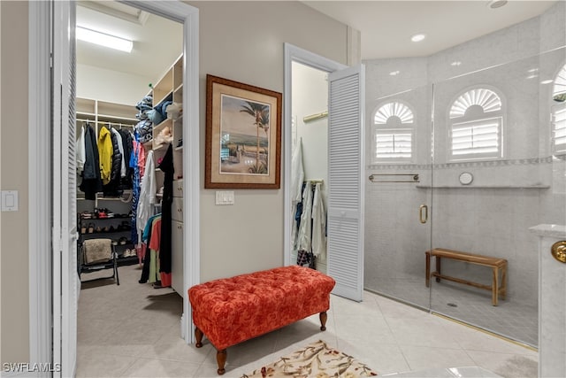 bathroom with tile patterned floors and a shower with door