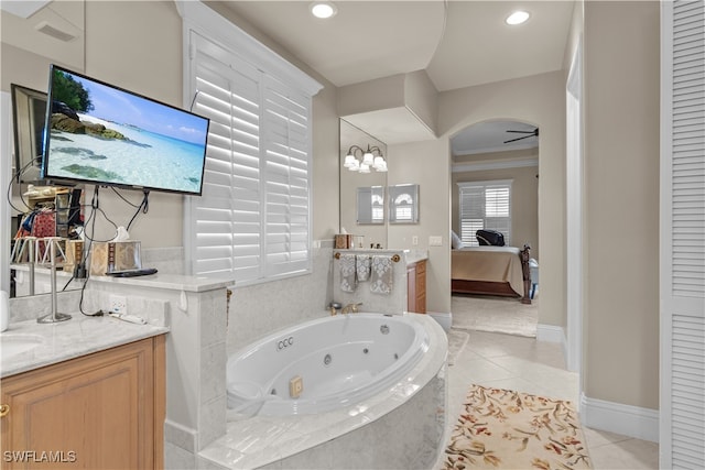 bathroom featuring tile patterned flooring, tiled tub, crown molding, vanity, and ceiling fan with notable chandelier