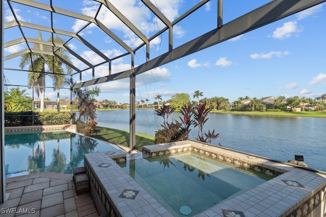 view of pool featuring a lanai, a water view, and an in ground hot tub