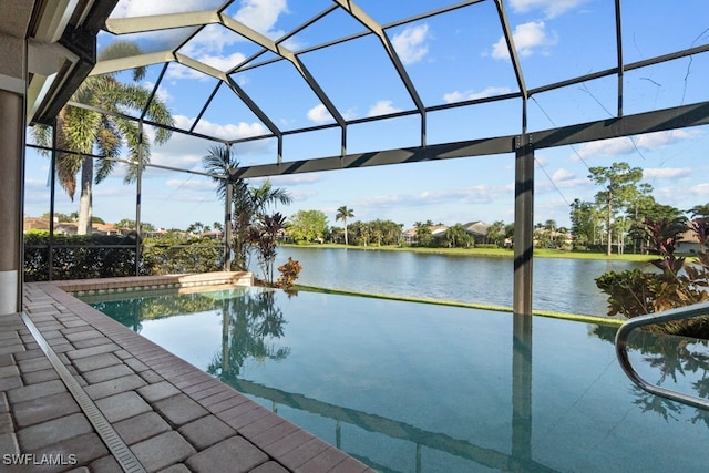 view of swimming pool featuring glass enclosure and a water view